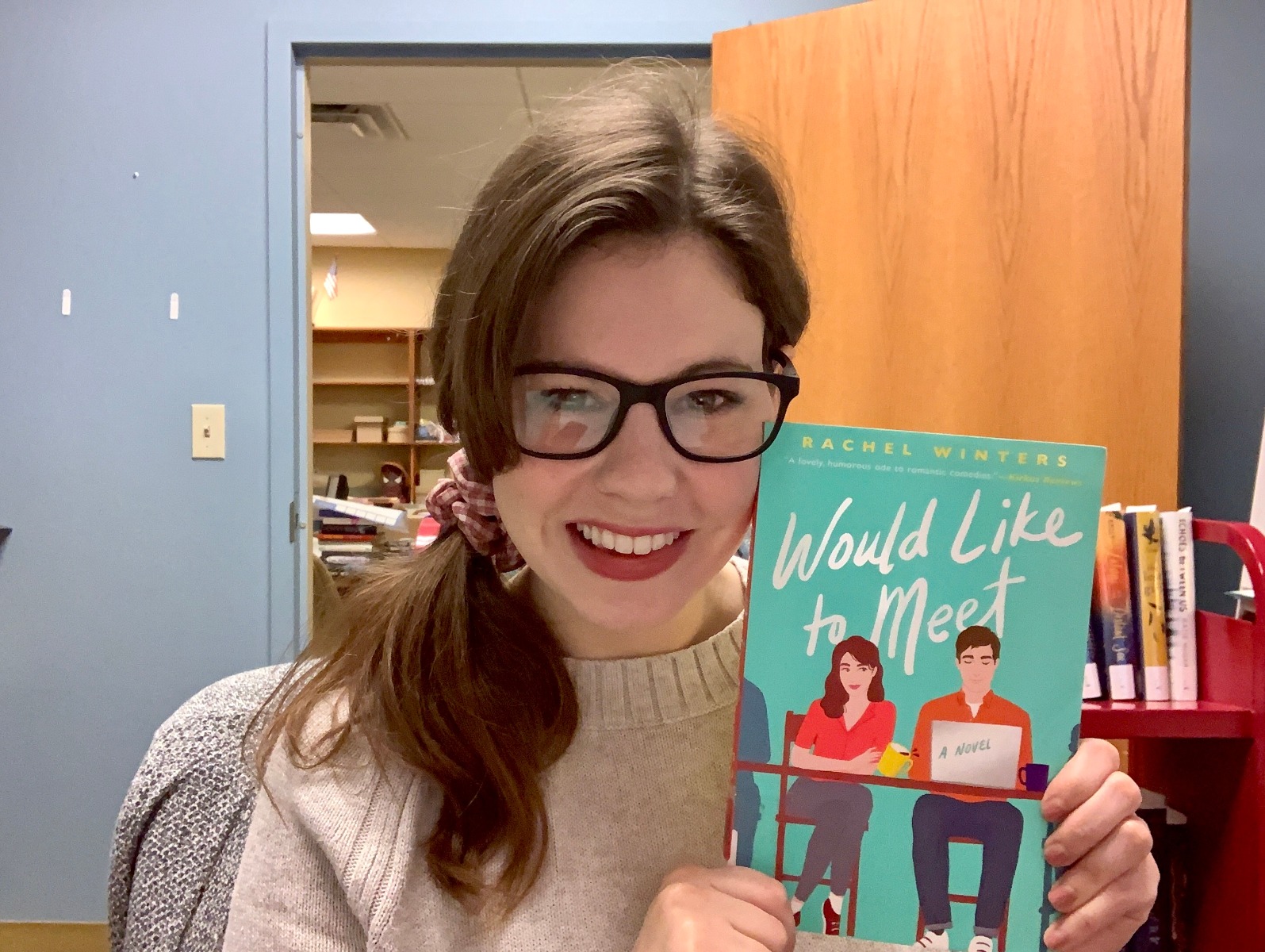 Kelsey holding the book "Would Like to Meet"