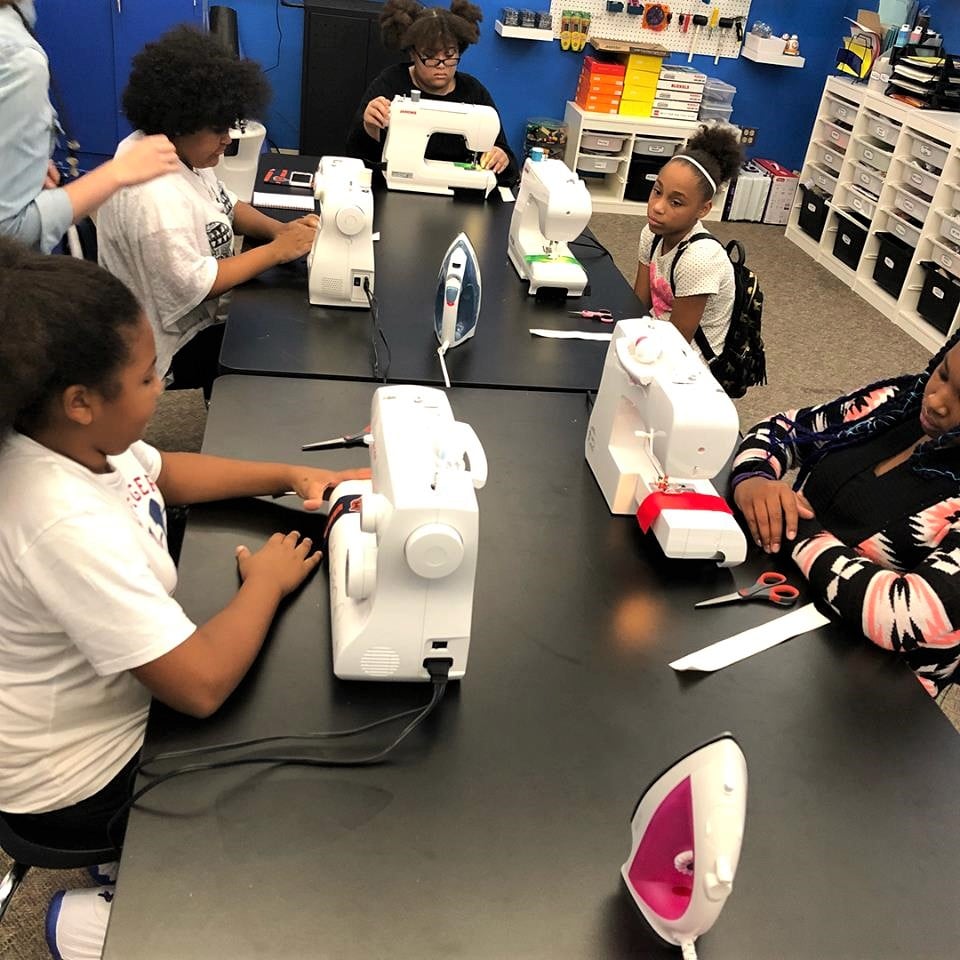 Sewing 1 - Intro to sewing. This program attracts many participants, like these teens gathered around 5 sewing machines and working on some scrunchies!